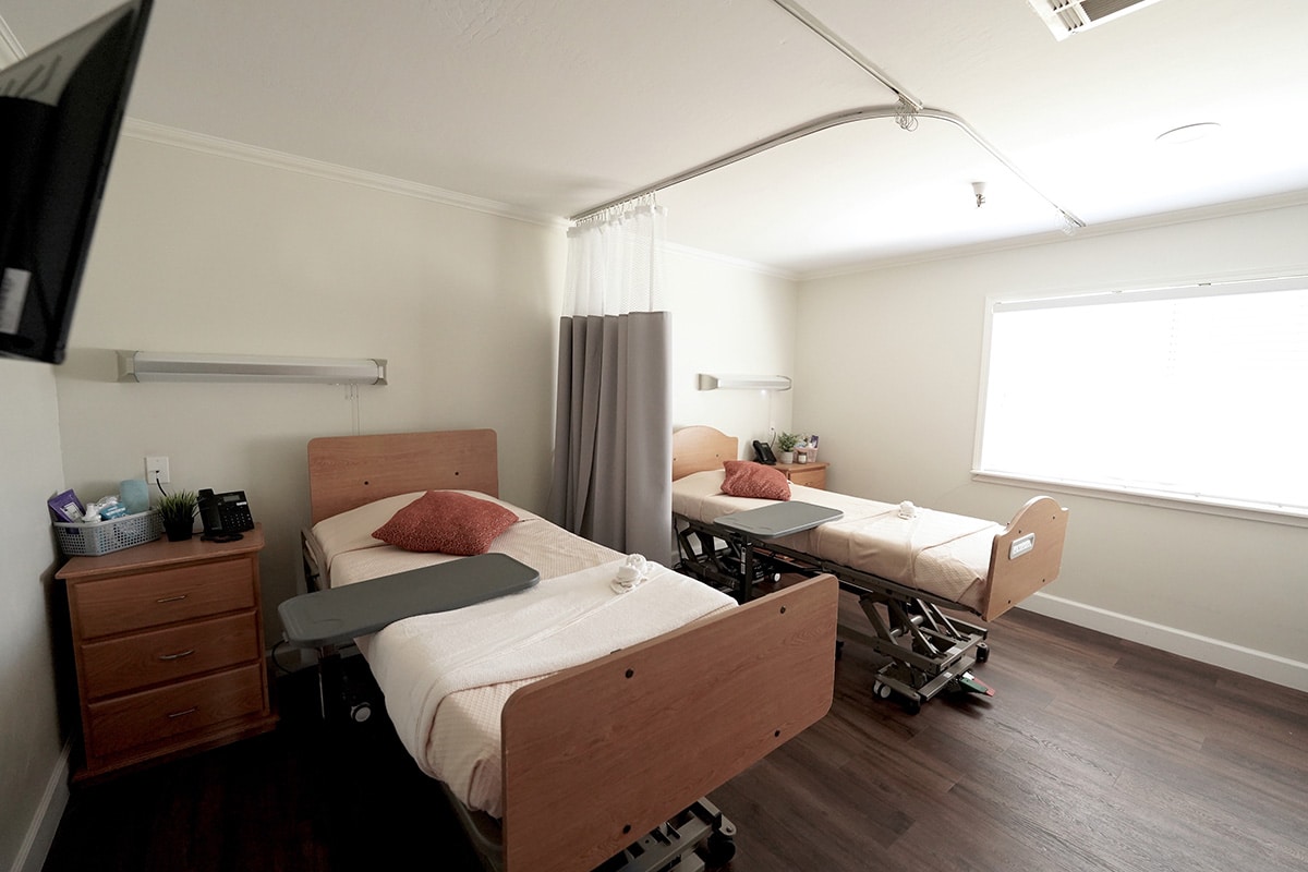 semi-private room with bright light coming into through the window at Concord Post Acute