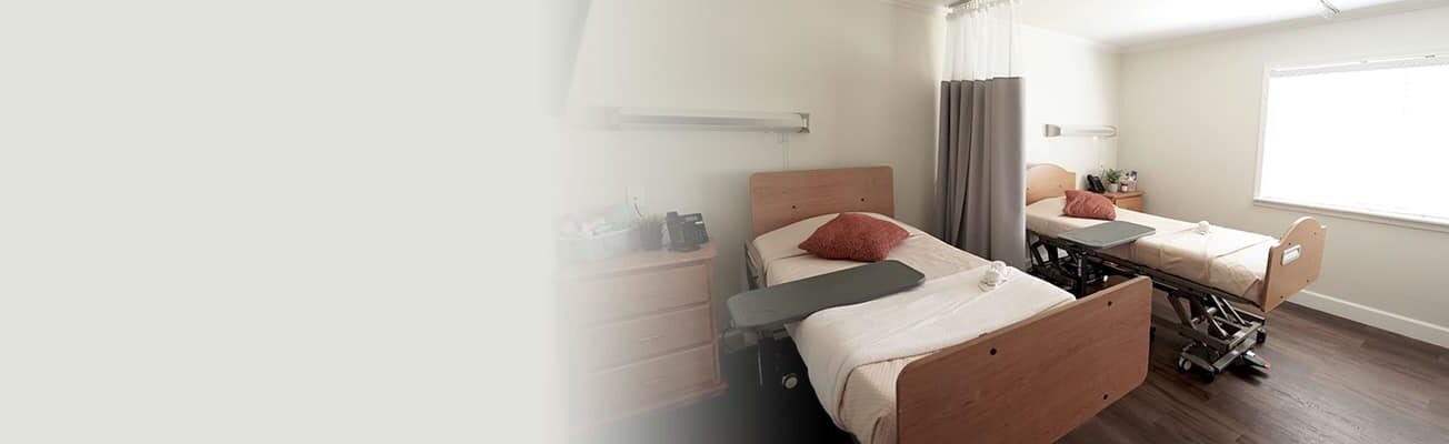 semi-private room with bright light coming into through the window at Concord Post Acute