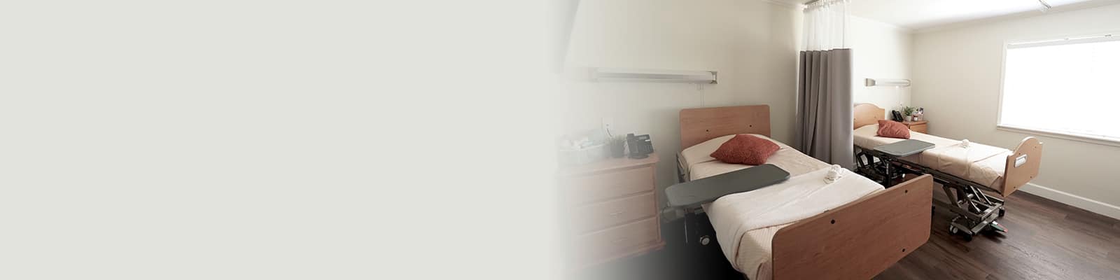 semi-private room with bright light coming into through the window at Concord Post Acute